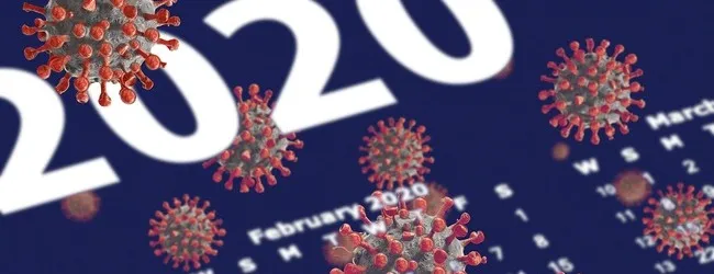 Abbildung: Corona-Viren in Vordergrund eines Kalenders 2020